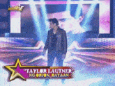 a man on a stage with the name taylor lautner