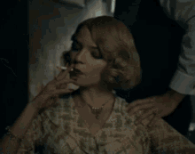 a woman wearing a necklace is being touched by a man in a white shirt