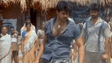 a man is standing in front of a group of people .