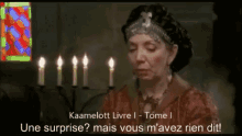 a man and a woman are sitting at a table with a surprise ? mais vous m'avez rien dit .