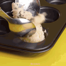 a muffin pan with a spoon in it that says mr.cakes on it
