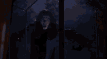 a person is surrounded by fire in a dark room