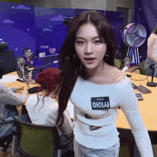 a woman with a name tag that says stayo stands in front of a microphone