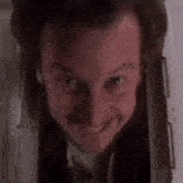 a close up of a man 's face with a slight smile on his face