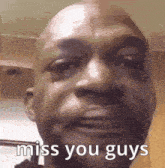 a close up of a man 's face with the words `` miss you guys '' on it .