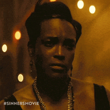 a close up of a woman 's face with #sinnersmovie written on the bottom right