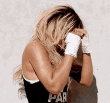 a woman wearing boxing gloves and a black shirt that says par