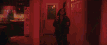 a woman is standing on a set of stairs in a room with a lamp