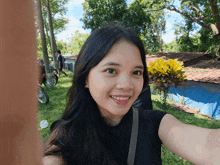 a woman taking a selfie with a yellow flower in the foreground
