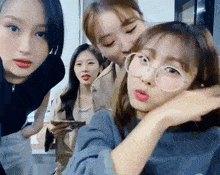 a group of young women are posing for a picture together .