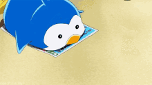 a blue penguin is laying on a piece of paper with chinese writing