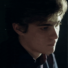 a close up of a young man 's face with a few spots on it