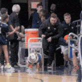 a group of people standing around a gatorade cart