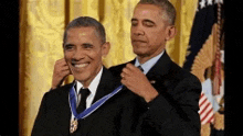 a man in a suit and tie is being awarded a medal .