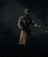 a man wearing an apron and a hat stands in the dark