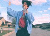 a man in a blue jacket is drinking from a bottle of water