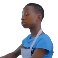 a young boy wearing a blue shirt and an apron looks to the side