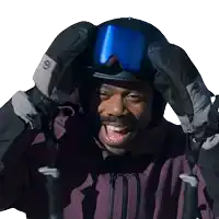 a man wearing a helmet and gloves with the letter s on them