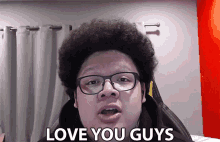 a man wearing glasses and headphones says love you guys