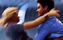 a man and a woman are hugging each other in a blurry picture .