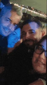 a group of people are posing for a picture and one of them has glasses on