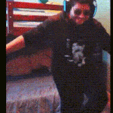 a person wearing headphones and sunglasses is standing in front of a bunk bed ..