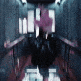 a blurry picture of a person in an elevator with a pink flower in the background