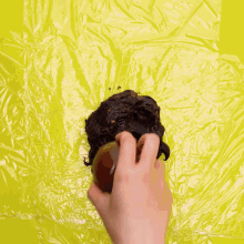 a person is holding a knife over a piece of chocolate