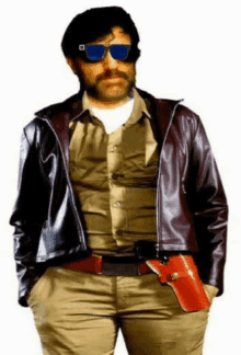a man wearing sunglasses and a leather jacket is holding a gun