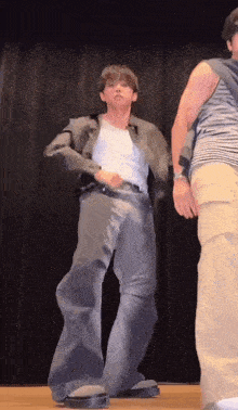 a man and woman are dancing on a stage .