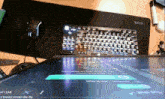 a keyboard sits on a desk next to a mouse and a screen that says " at leak "