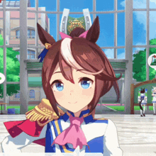 a girl with brown hair and blue eyes is standing in front of a building with a horseshoe on it