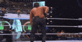 a man in a wrestling ring with the word aew on the side of it