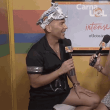 a man wearing a tin foil hat is talking into a microphone
