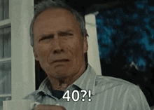 a man in a striped shirt is holding a cup of coffee and saying `` 40 ? '' .