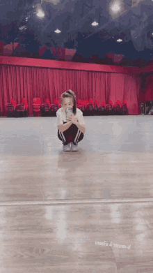 a girl taking a picture of herself in front of a large mirror