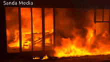 a building that is on fire with the words sanda media on the bottom