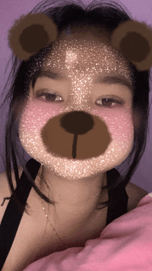 a girl with a teddy bear face mask on her face