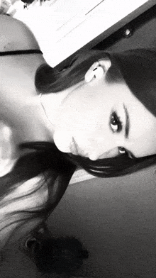 a black and white photo of a woman 's face with her eyes closed