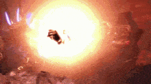 a person is standing in front of a large explosion in a dark room .