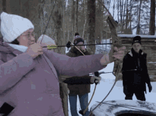 a woman is holding a bow and arrow in her hand
