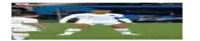 a soccer player in a white uniform is standing on a field .