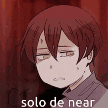 a cartoon of a boy with red hair and green eyes with the words solo de near written on it .