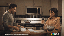 a man and a woman in a kitchen with nbc written on the bottom of the screen