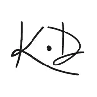 a pink circle with the letter k.d. inside of it