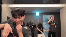 a group of people wearing orange jerseys are dancing