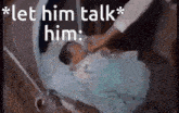 a baby is laying in a crib and a person is talking to it .