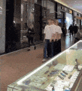 a group of people are standing in a line in front of a store that says tpm