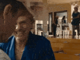 a man and a woman are laughing together in a room .