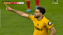 a soccer player wearing a yellow jersey that says jd